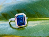 2.6ct Emerald Cut Blue Emerald Bezel Set Solitaire Ring 14k White Gold Finish